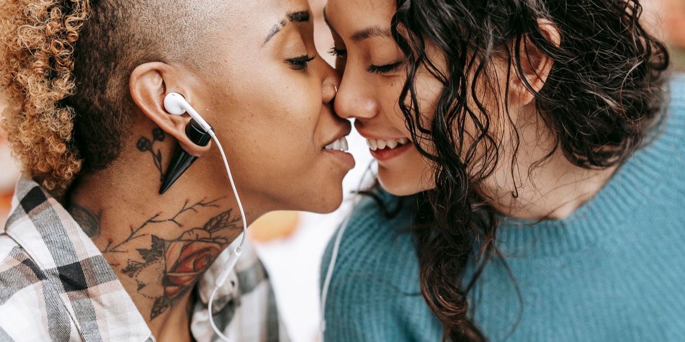 Two women with foreheads touching in a tender moment